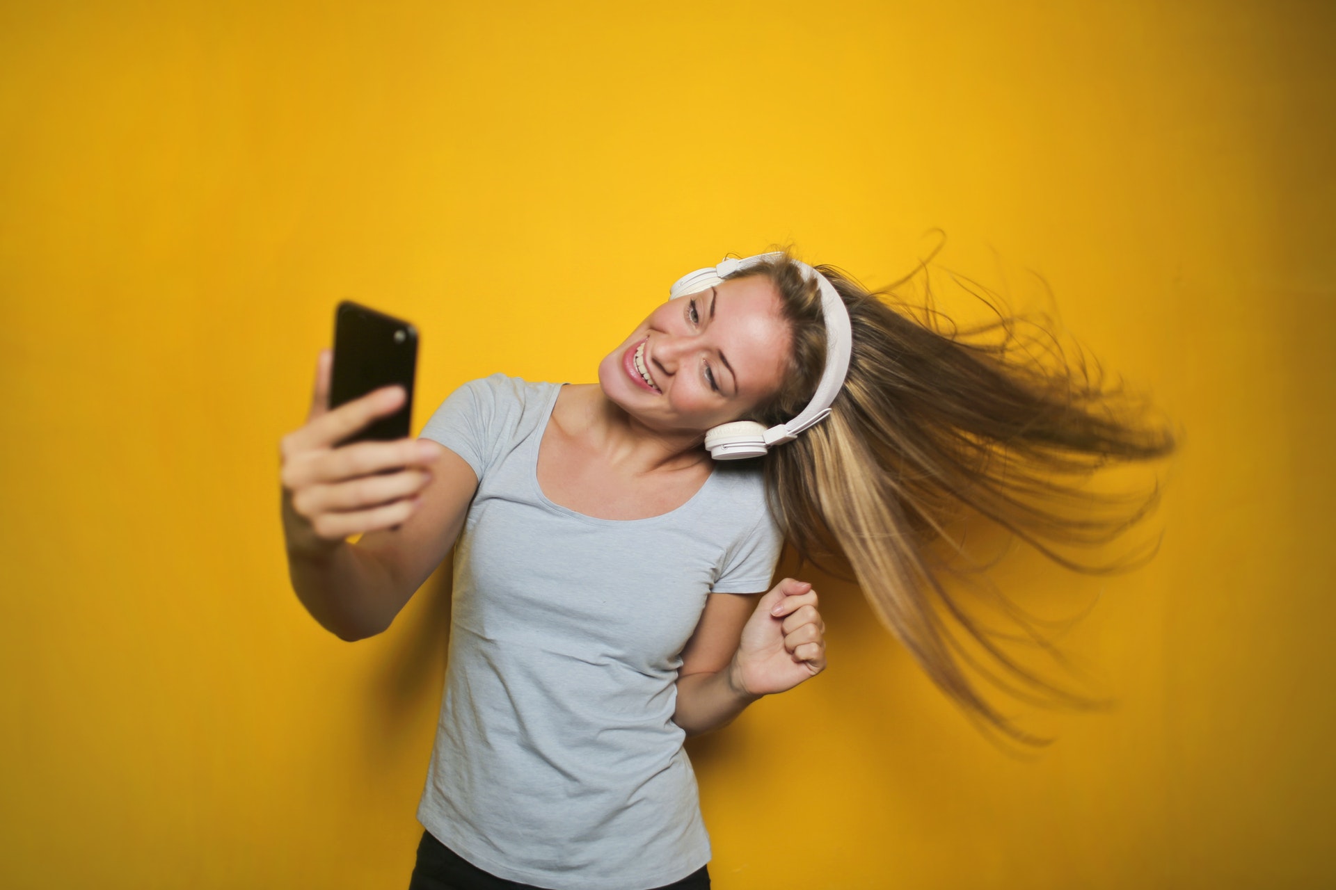 Girl enjoying portable music with headphones on