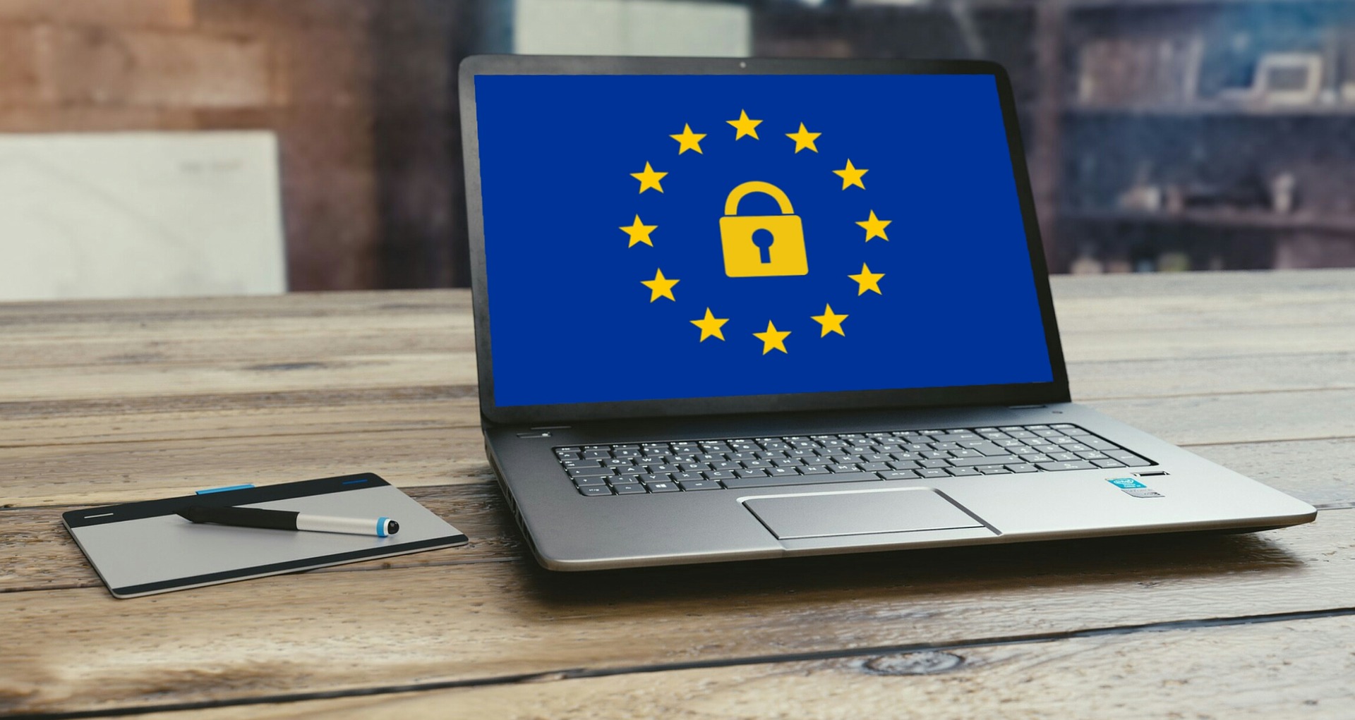 Laptop on desk with GDPR background image
